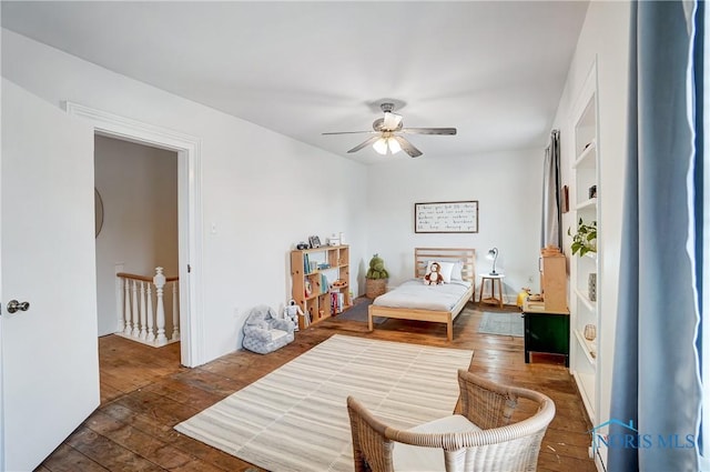 bedroom with ceiling fan and dark hardwood / wood-style floors