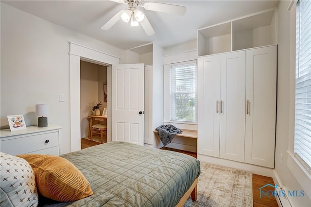 bedroom with ceiling fan and wood-type flooring