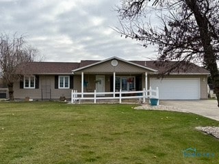 ranch-style home with a garage and a front yard