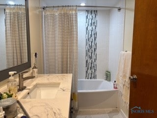 bathroom featuring vanity and shower / bathtub combination with curtain