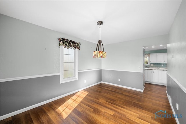 unfurnished dining area with dark hardwood / wood-style floors