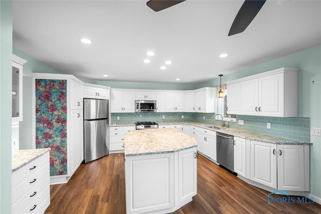 kitchen with white cabinetry, sink, hanging light fixtures, dark wood-type flooring, and appliances with stainless steel finishes