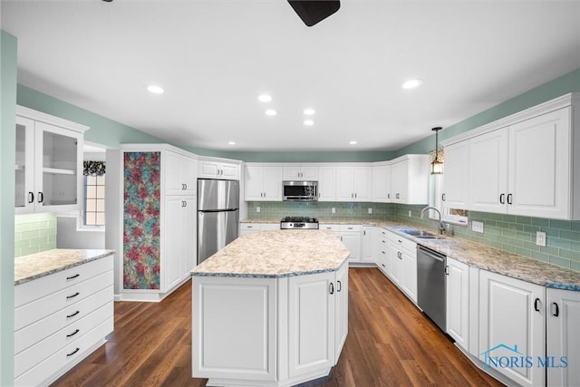 kitchen with white cabinetry, dark hardwood / wood-style flooring, pendant lighting, and appliances with stainless steel finishes