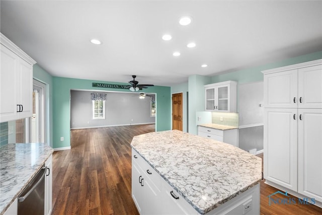 kitchen featuring ceiling fan, white cabinets, and dark wood-type flooring