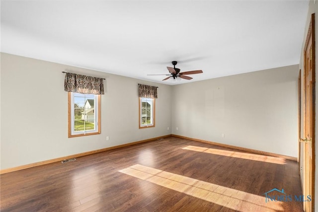 spare room featuring dark hardwood / wood-style floors and ceiling fan