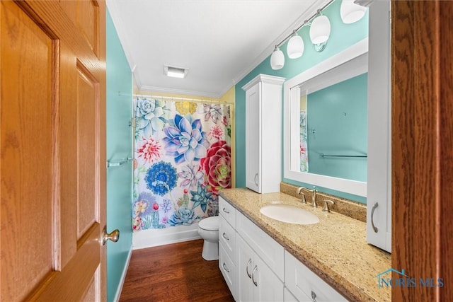 full bathroom with shower / bath combination with curtain, vanity, crown molding, hardwood / wood-style flooring, and toilet