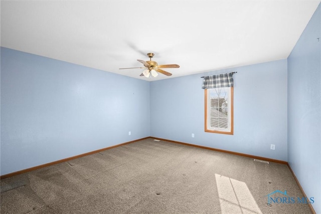 carpeted spare room with ceiling fan