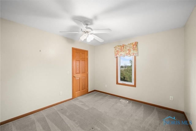 empty room with carpet flooring and ceiling fan