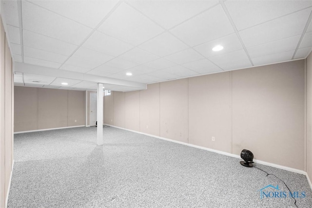 basement featuring carpet flooring and a paneled ceiling