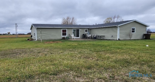 rear view of house with a yard and a patio