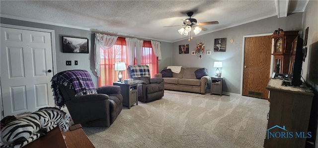 carpeted living room with ceiling fan, lofted ceiling, a textured ceiling, and ornamental molding