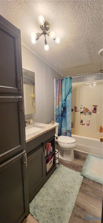 full bathroom with vanity, hardwood / wood-style flooring, toilet, shower / bath combo with shower curtain, and a textured ceiling