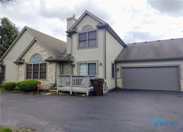 view of front of house with a garage and a wooden deck