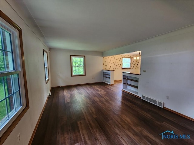 unfurnished living room with dark wood-type flooring