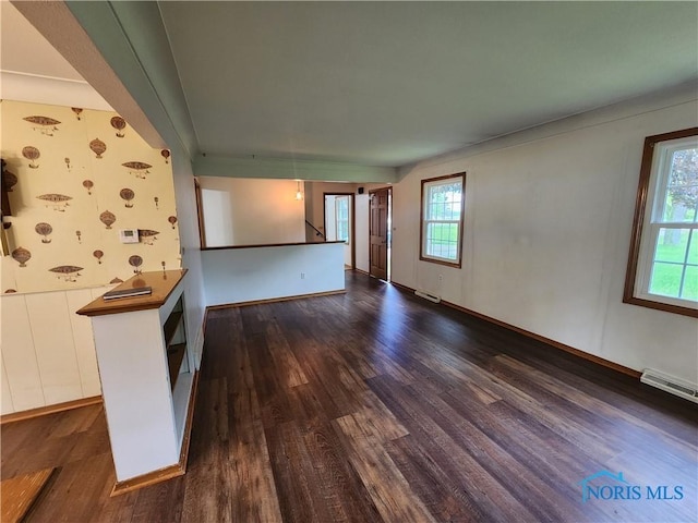 unfurnished living room with dark wood-type flooring