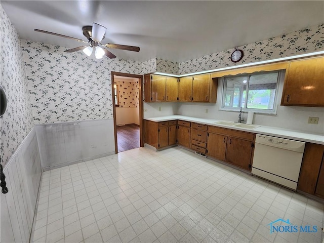 kitchen with white dishwasher, ceiling fan, and sink