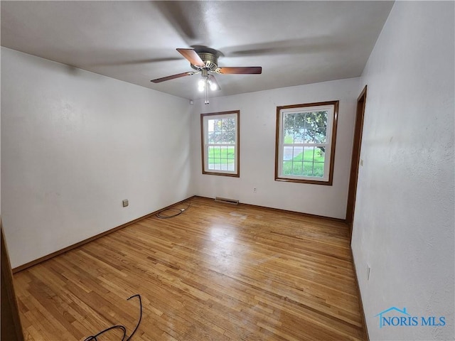 unfurnished room with ceiling fan and light hardwood / wood-style floors