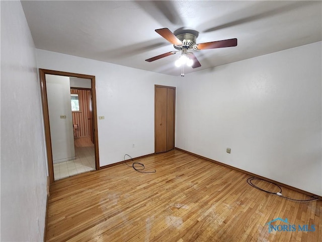 unfurnished bedroom with ceiling fan and light hardwood / wood-style floors