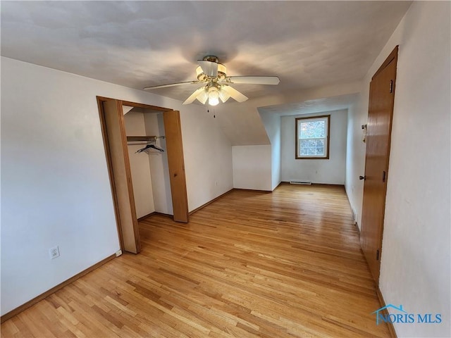 bonus room with light hardwood / wood-style flooring and ceiling fan