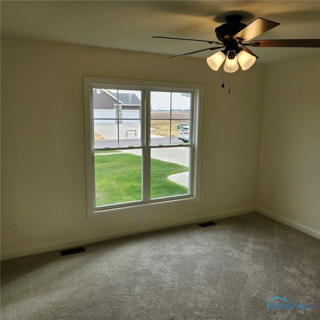 empty room with carpet flooring and ceiling fan