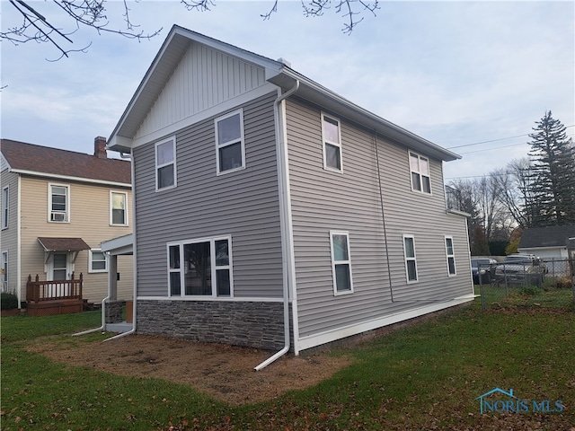 view of property exterior with a lawn