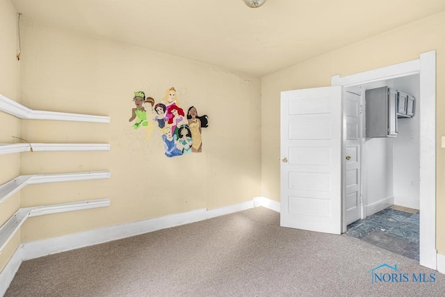 interior space featuring carpet floors and vaulted ceiling