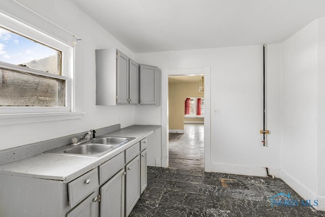 kitchen with gray cabinetry and sink