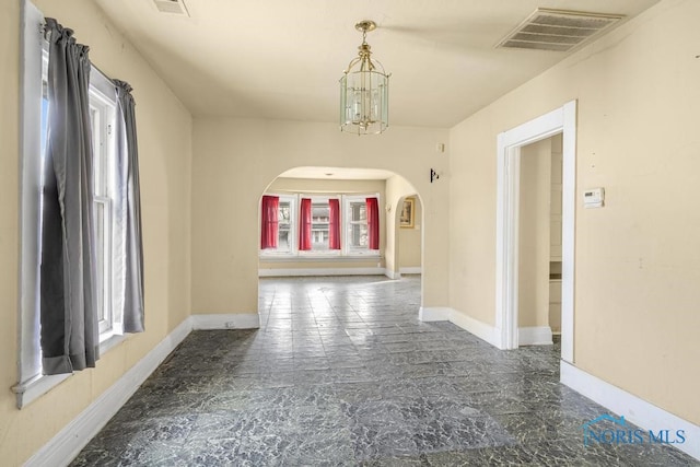 corridor featuring a chandelier