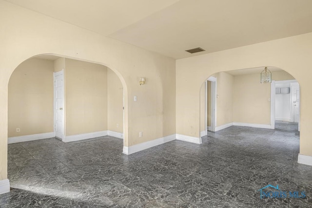 empty room with an inviting chandelier