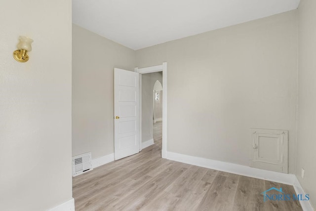 empty room with light hardwood / wood-style flooring