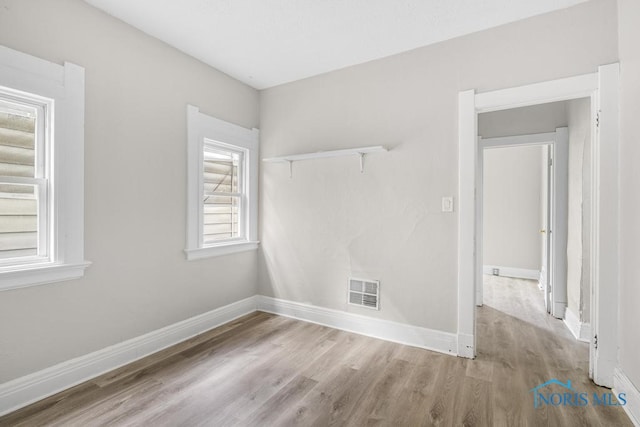 empty room with light hardwood / wood-style floors