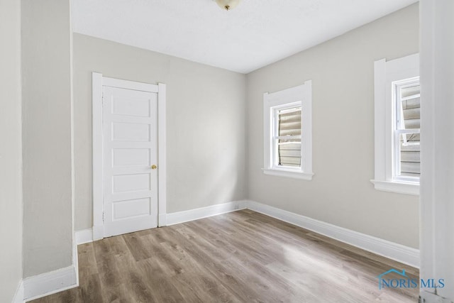 spare room with wood-type flooring