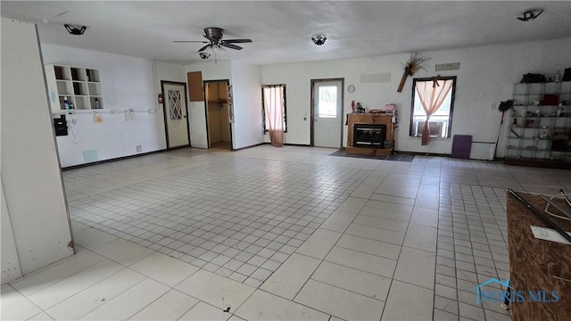 unfurnished living room featuring ceiling fan