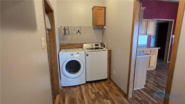 laundry area featuring washer and dryer and dark wood-type flooring