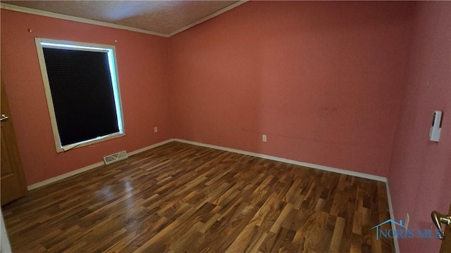 unfurnished room with dark hardwood / wood-style floors and crown molding