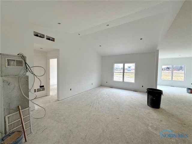 unfurnished living room with lofted ceiling and a wealth of natural light