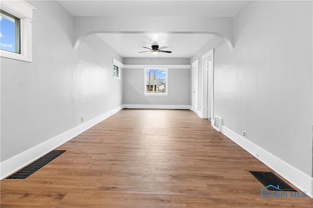 spare room with hardwood / wood-style flooring, a wealth of natural light, and ceiling fan