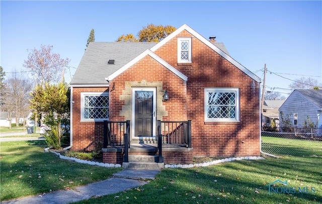 bungalow-style house featuring a front yard