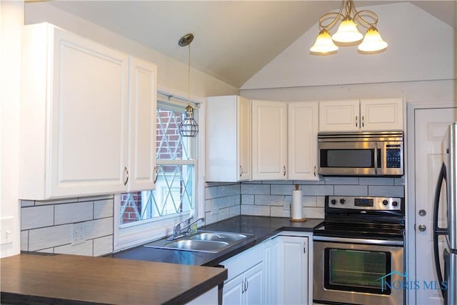 kitchen featuring white cabinets, sink, tasteful backsplash, decorative light fixtures, and stainless steel appliances