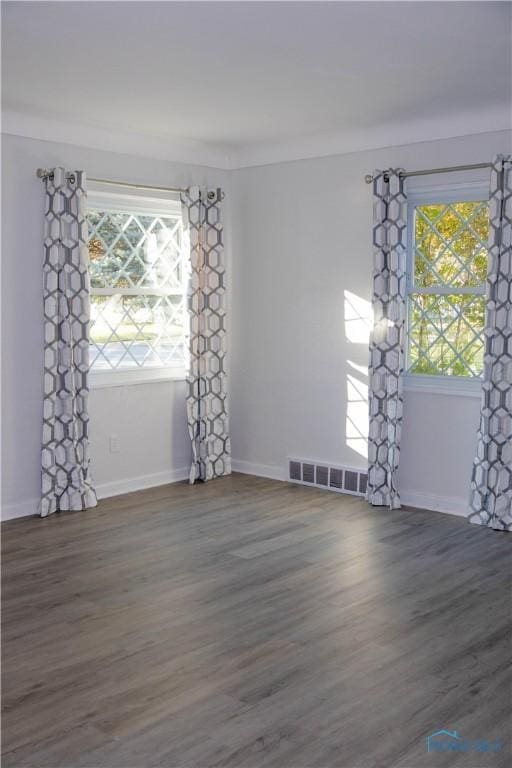 unfurnished room featuring dark hardwood / wood-style floors