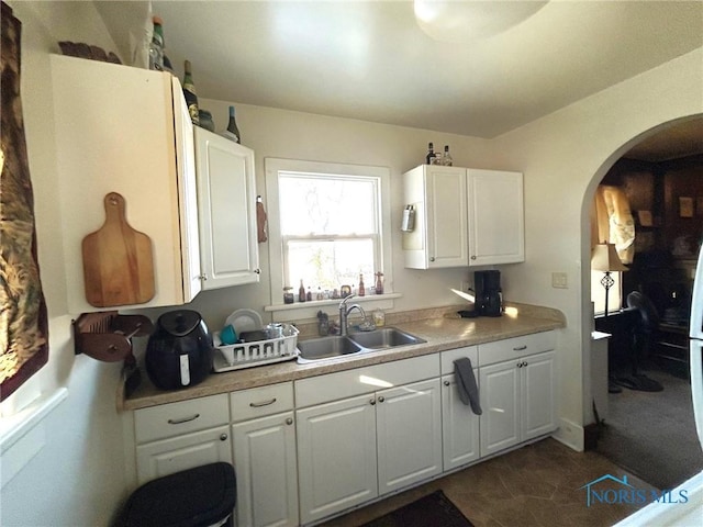 kitchen featuring sink and white cabinets