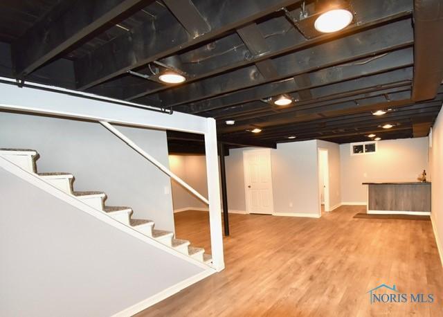 basement with hardwood / wood-style flooring