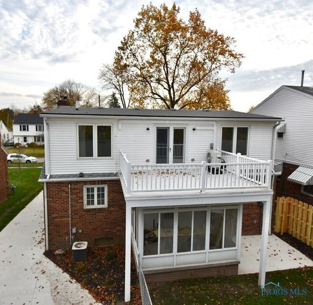 back of property featuring a balcony