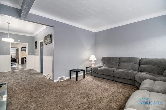 living room featuring carpet flooring and beam ceiling