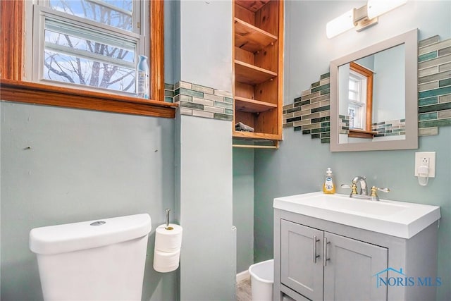 bathroom featuring vanity, backsplash, and toilet