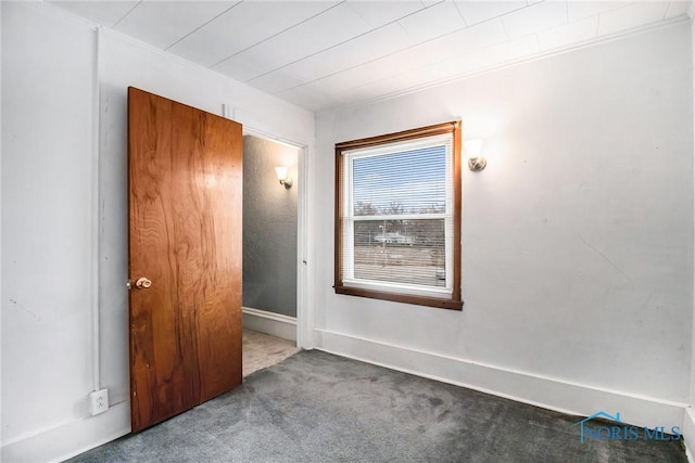 interior space featuring dark carpet and crown molding