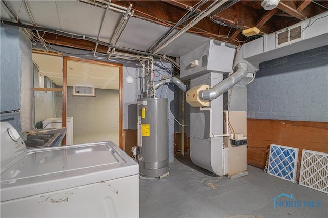 utility room featuring washer / dryer, gas water heater, and heating unit