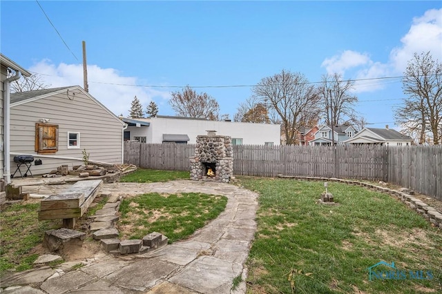 view of yard featuring an outdoor stone fireplace