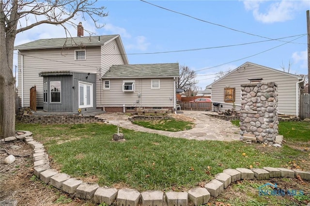 back of property featuring french doors, a patio area, and a lawn