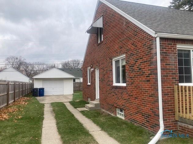 view of property exterior featuring a garage and an outdoor structure